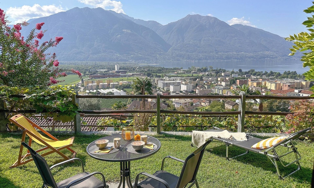 Gordola Apartment | Vacation apartment with panoramic view and outdoor pool, garden seating area and sunbathing lawn