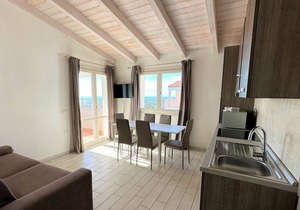 Attic three-room apartment with panoramic sea view, shared swimming pool and parking space