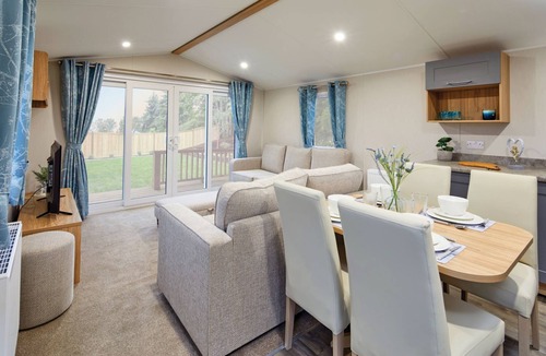 Dunbar House | Well appointed caravan with patio doors and decking.